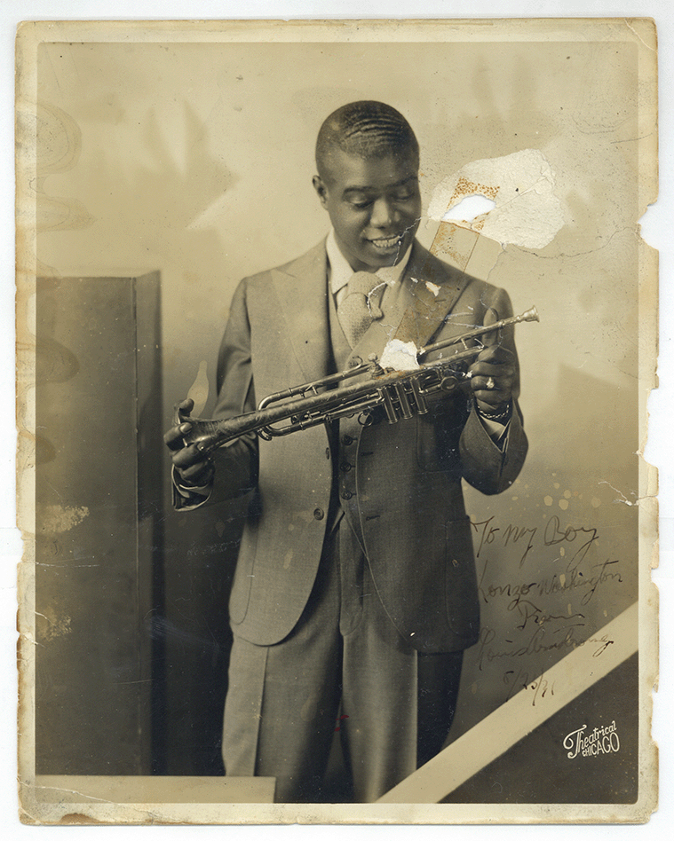 Louis Armstrong looking down at trumpet he is holding; Photo is signed "To my Boy Lonzo Washington From Louis Armstrong 8/23/31," Courtesy of the New Orleans Jazz Club, Louisiana State Museums 1978.118(B).00142.1