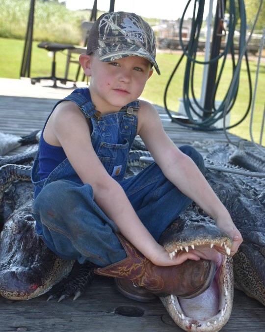 Bohan “Bo” DeHart with Alligator, 2017. This photo was taken at Johnny’s Seafood alligator dock in Berwick, Louisiana. Courtesy of the DeHart family.
