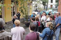 Walking tour group listens closely as their guide unveils enlightening historic facts about New Orleans neighborhoods